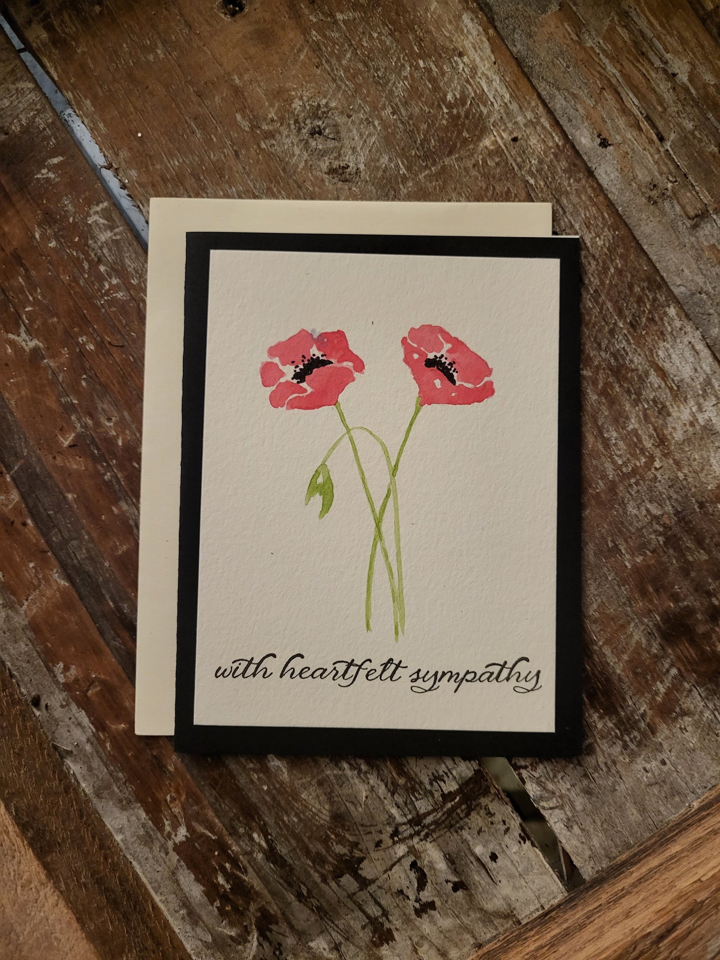 Two pink poppies are painted on this With Heartfelt Sympathy card.