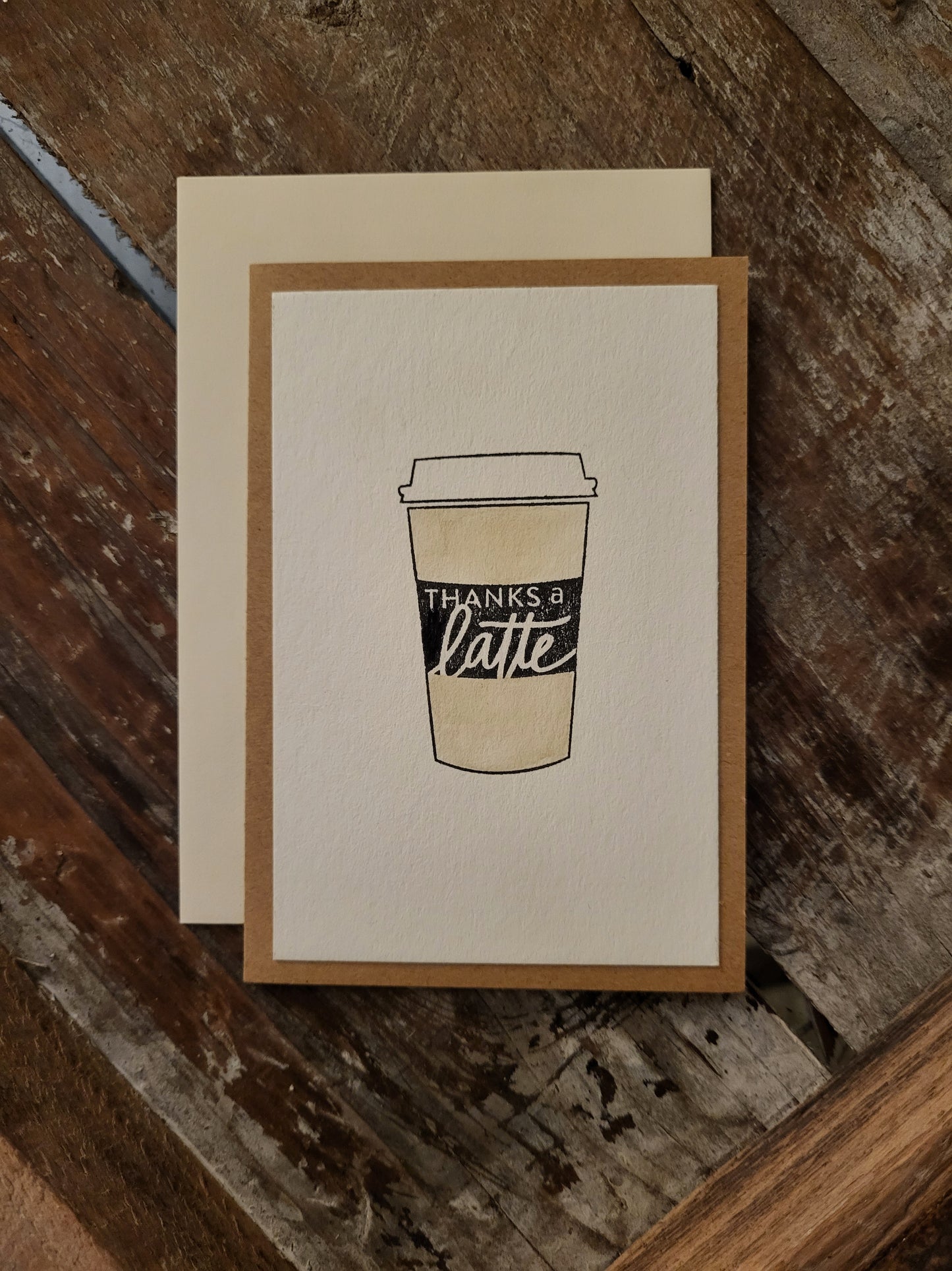 A coffee cup is depicted with a stamp that says Thanks a Latte